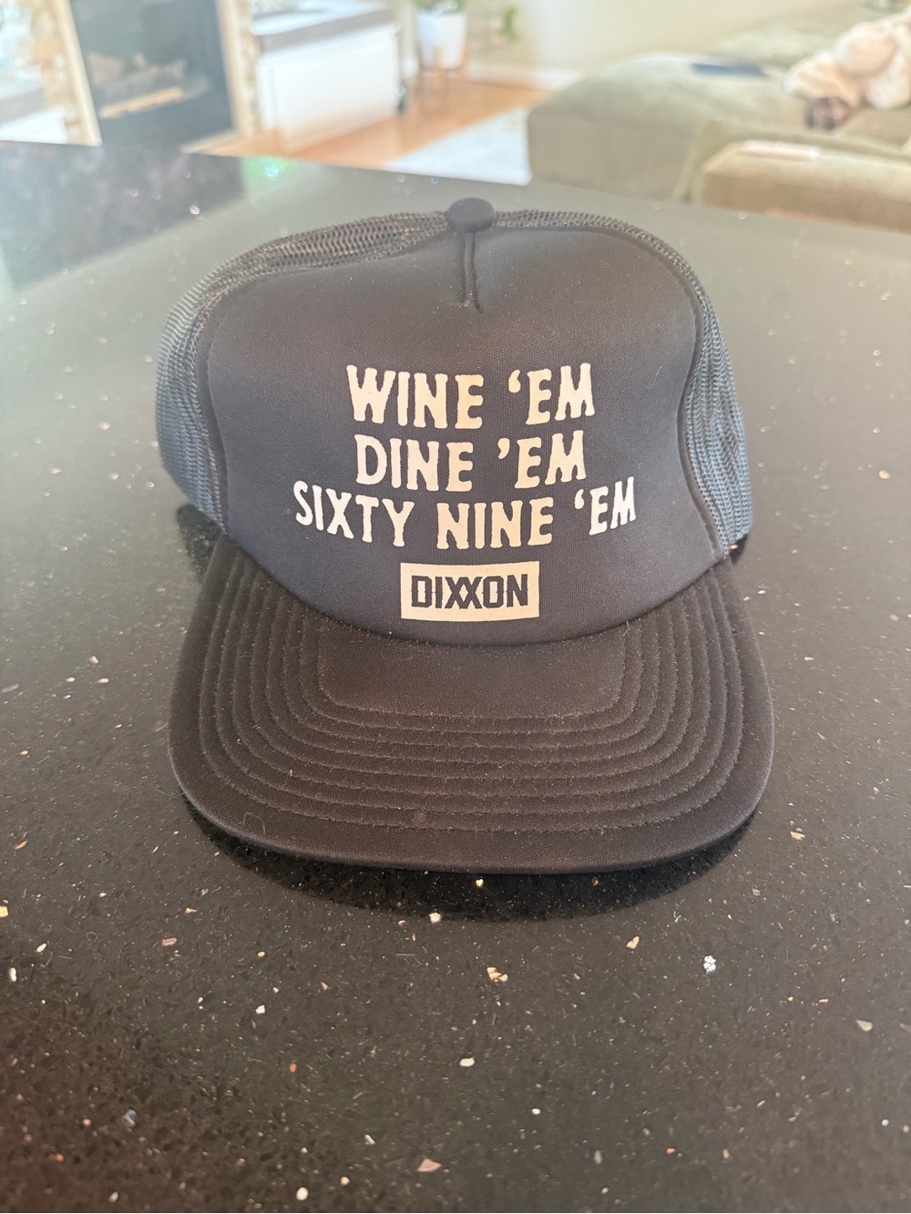 DIXXON Black Trucker Hat with White Text - "Wine 'Em Dine 'Em Sixty Nine 'Em"